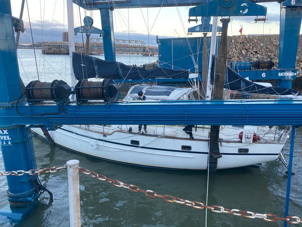 Voyager in being lifted back into the water via boat hoist